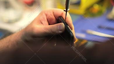 Expert Phone Repair Techniques Demonstrated in a Workshop Setting Focusing on Meticulous Screen Replacement