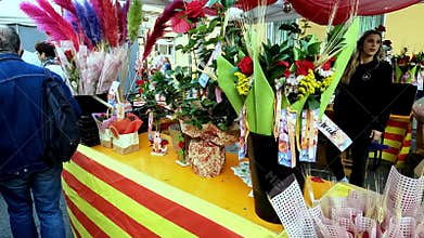 Barcelona, Spain-June 24, 2025. Florist selling roses and bouquets at a market stall decorated with catalan flag colors for saint
