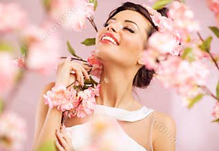 Pleased brunette woman among the flowers