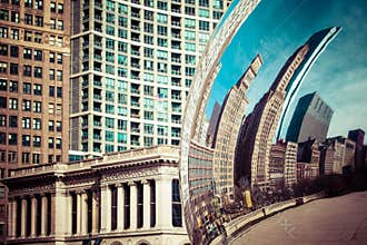 CHICAGO, IL - APRIL 2: Cloud Gate and Chicago skyline on April 2, 2014 in Chicago, Illinois. Cloud Gate is the artwork of Anish