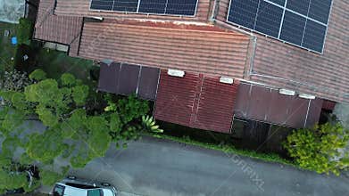 Solar energy with cell panels or PV modules installed on top of house rooftop.