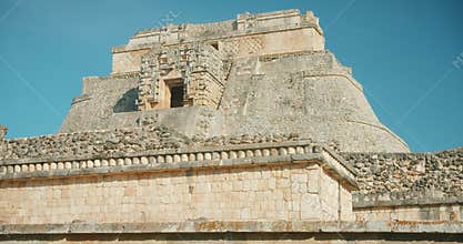 Front view of the Pyramid of the Magician with decorative elements in Uxmal archaeological site in Yucatan, Mexico