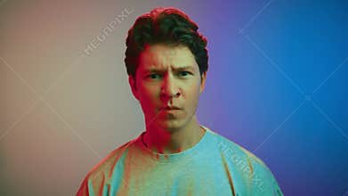 Angry portrait of mad young man with unhappy face looking at camera with hate