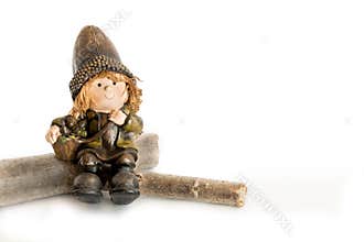 Elf Figurine Sitting on Wooden Logs