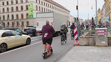 Urban video shows dynamic street life with bikes, scooters, and people
