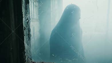 A creepy ghostly apparition in human form moves through an old haunted house