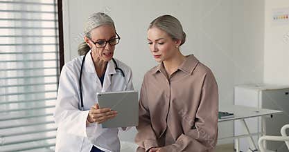 Cardiologist using tablet provide consultation to patient