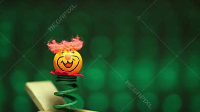 Little clown surprize from wood box with blurry flashing background