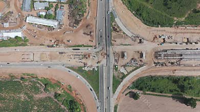 Aerial view drone footage of bridge construction being made across the intersection