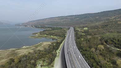 M6 motorway Expressway Nakhon Ratchasima Thailand with river and mountain. Drone footage of scenic landscape rural place traffic