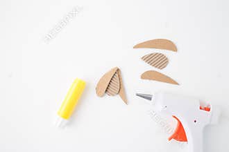 assembly of the cardboard pieces using the glue stick or hot gun. step in creative process, DIY handmade bug project