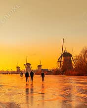 Local Dutch people skating on the frozen canal of the Kinderdijk Unesco World Heritage site