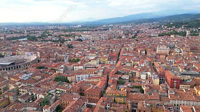 Aerial view of the city of Verona with its arena and the Adige River, and mountain in the background