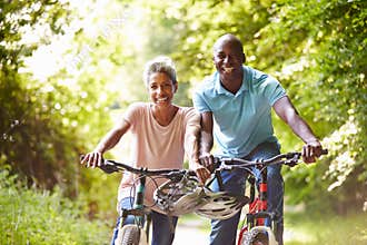Mature African American Couple On Cycle Ride In Countryside