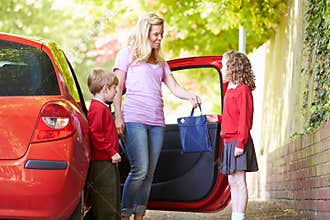 Mother Driving To School With Children