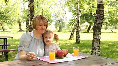 Mother and daughter eat and drink
