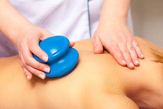 Spa salon. Woman relaxing having cupping-glass massage. Bodycare.