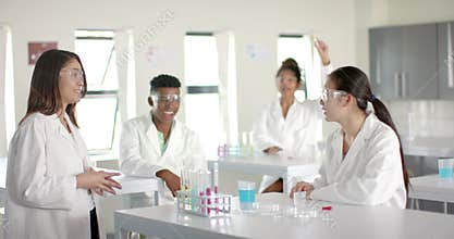 Diverse students collaborate in high school chemistry lab