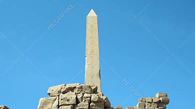 View of a tall obelisk in the ancient city of Karnak