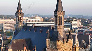 Aachener Rathaus with fortifications and spires, and architectures in the background in Germany
