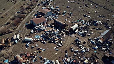 Aerial View of Illegal Dumping Site with Scattered Waste on Field