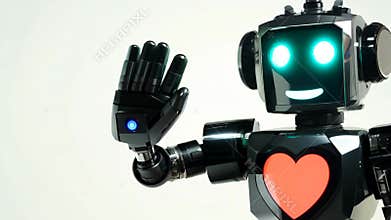 A robot with a heart on its chest is waving.