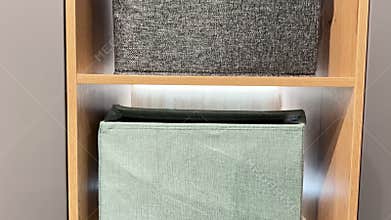 Stylish and modern storage bins neatly arranged on a wooden shelf enhance your decor