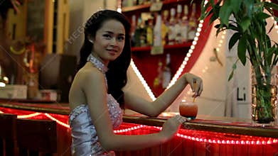 gorgeous asian woman alone at bar