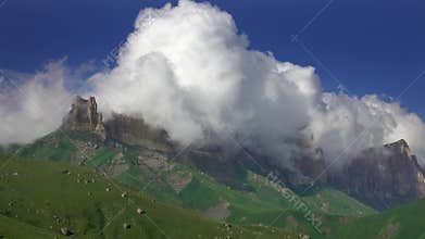 Caucasus mountains under moving clouds