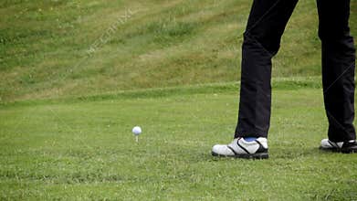 Golfer shooting a golf ball
