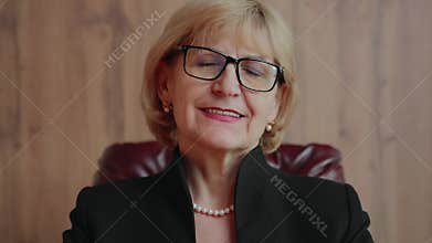 Senior female executive nodding with approval