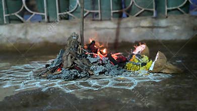 Holika Dahan, ritual bonfire and painting with colors on the evening before the holi festival in India, symbol for burning