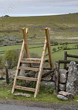 Wooden ladder over dry stone wall