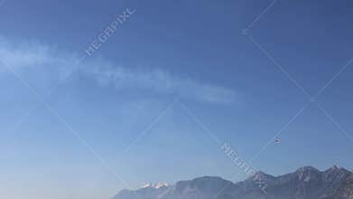 The F16 fighter performs aerobatics over the sea against the background of mountains