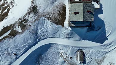 Top down view piste in winter in Schwarzsee. Rocks covered with snow in Zermatt ski areal. Aerial drone shot