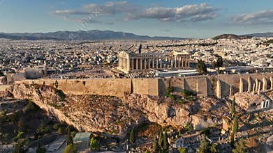Aerial views of Athens showcasing ancient acropolis and stunning city landscape during sunrise. Fly above iconic