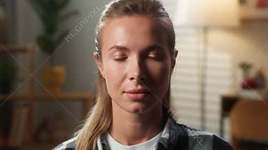 Portrait serious adult female woman lady looking at camera with calm confident face emotion sitting on sofa in living