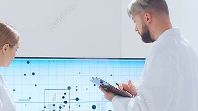 Scientific laboratory filled with various research equipment. Scientists are conducting experiments and research