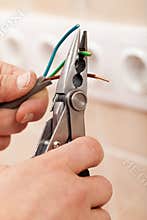 Electrician hands with pliers and wires