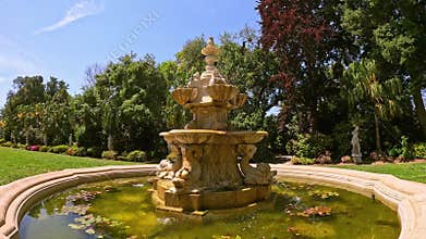 footage of a water fountain with lush green trees and flowers at Huntington Library and Botanical Gardens in San Marino California