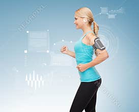 Sporty woman running with smartphone and earphones