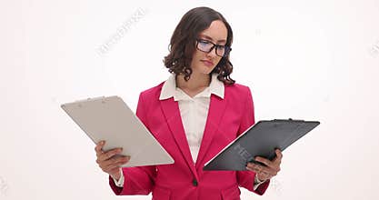 Businesswoman compares documents looking at clipboards on white