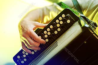 Closeup image of musician playing on accordion