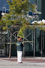 Political activist holds up a sign saying - vote green, Vancouver BC