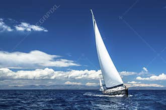 Ship yachts with white sails in the open Sea. Luxury boats.