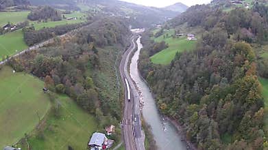 Aerial view of the Alps in Austria, mountains, river and railroad