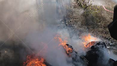 Fireman extinguishes the fire with a water jet