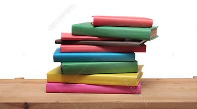 Books on wooden shelf close-up isolated white