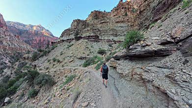 Following Man Backpacking into the Grand Canyon