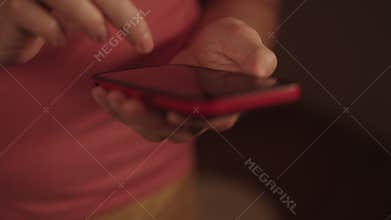 Male hands holding modern cell phone, fingers tapping and swiping on screen while texting, chatting, using online